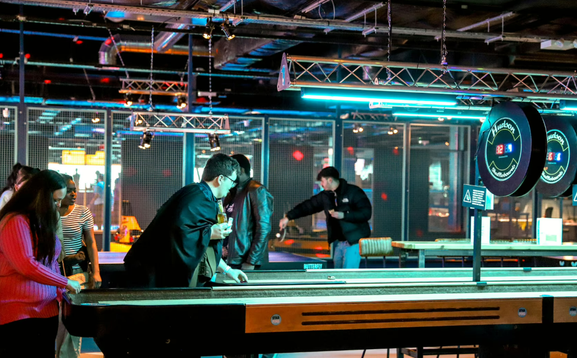 "Shufflepong Zone at Star Pins, lively shuffleboard games for team-building events."