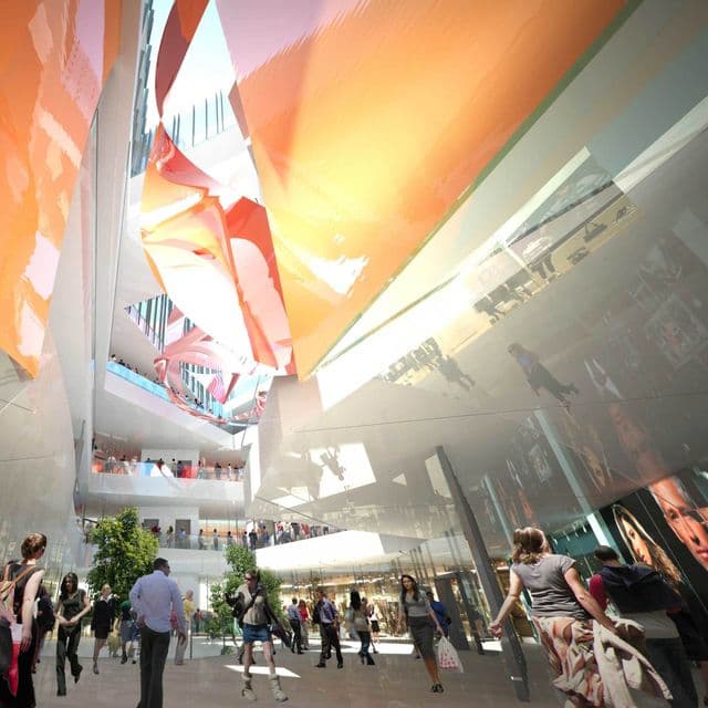 Modern event space with high ceilings and colorful drapery for conferences and workshops.