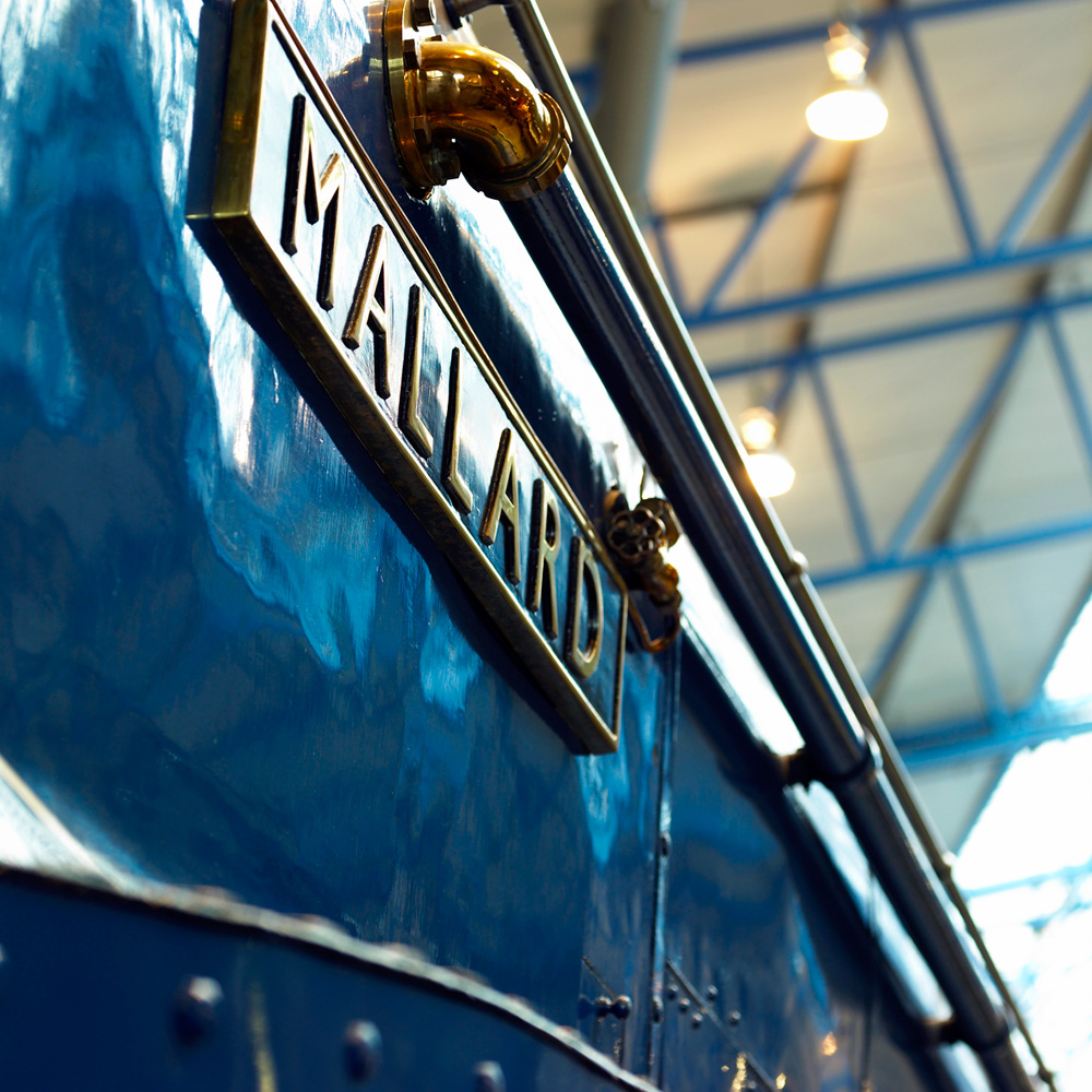Vintage Mallard train with polished exterior at National Railway Museum for events or meetings.