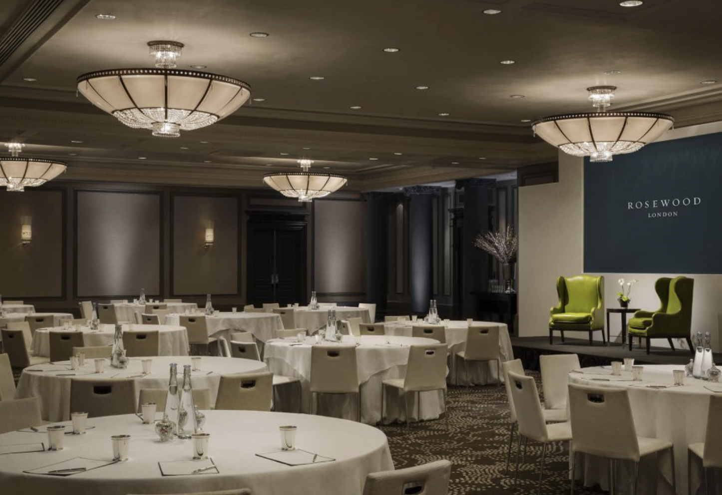 Elegant Grand Ballroom with round tables, ideal for formal meetings and banquets.