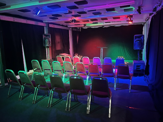 Compact Premier Room 1 setup for workshops and presentations with a podium.