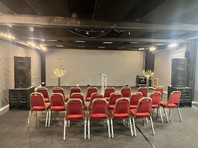 Premier Room 3 at Robannas Studios, featuring red chairs for workshops and presentations.