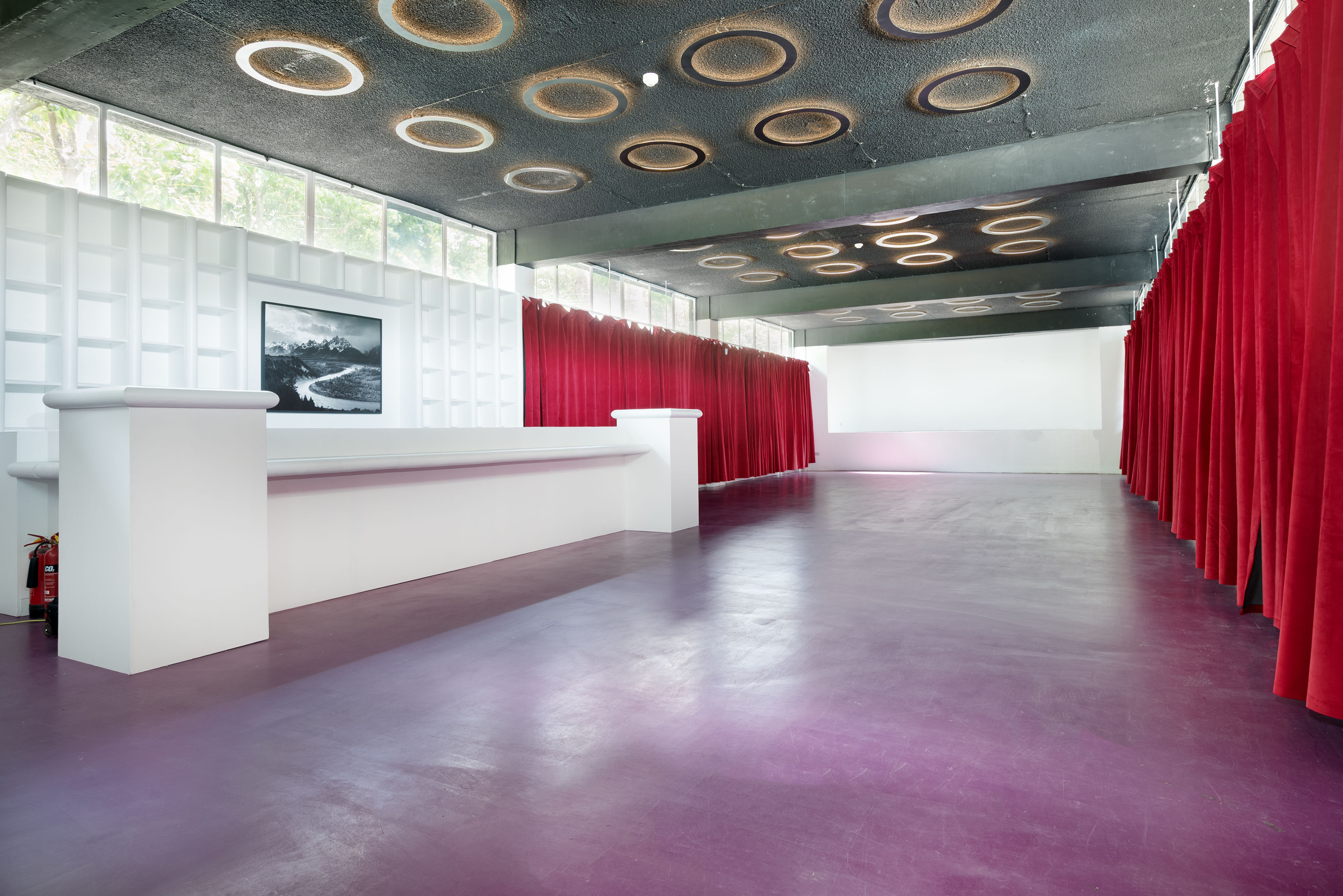 Red Velvet Venue at Proposition Studios: modern event space with red curtains, ideal for meetings.
