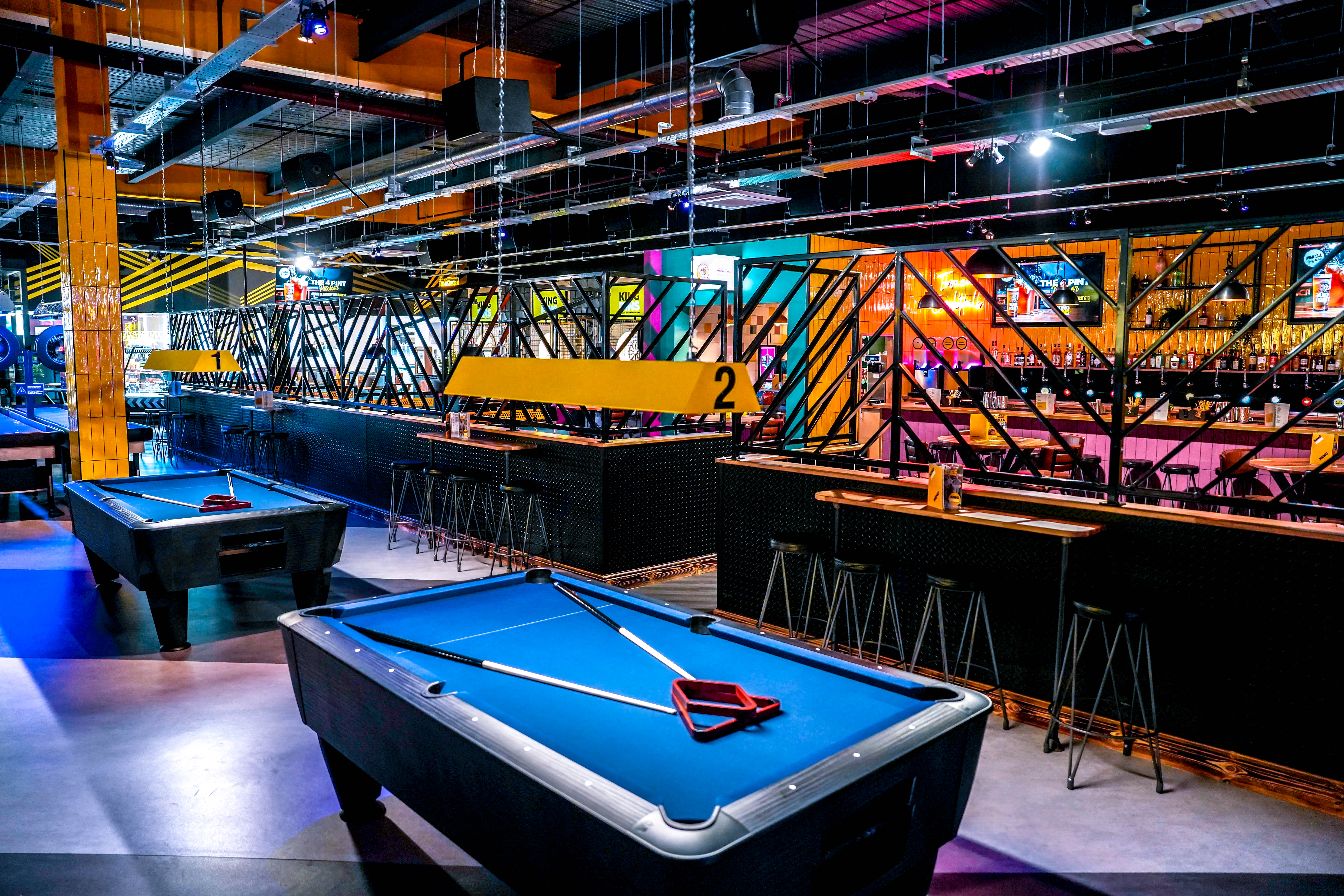 Modern entertainment venue with pool tables, ideal for corporate events and gatherings.