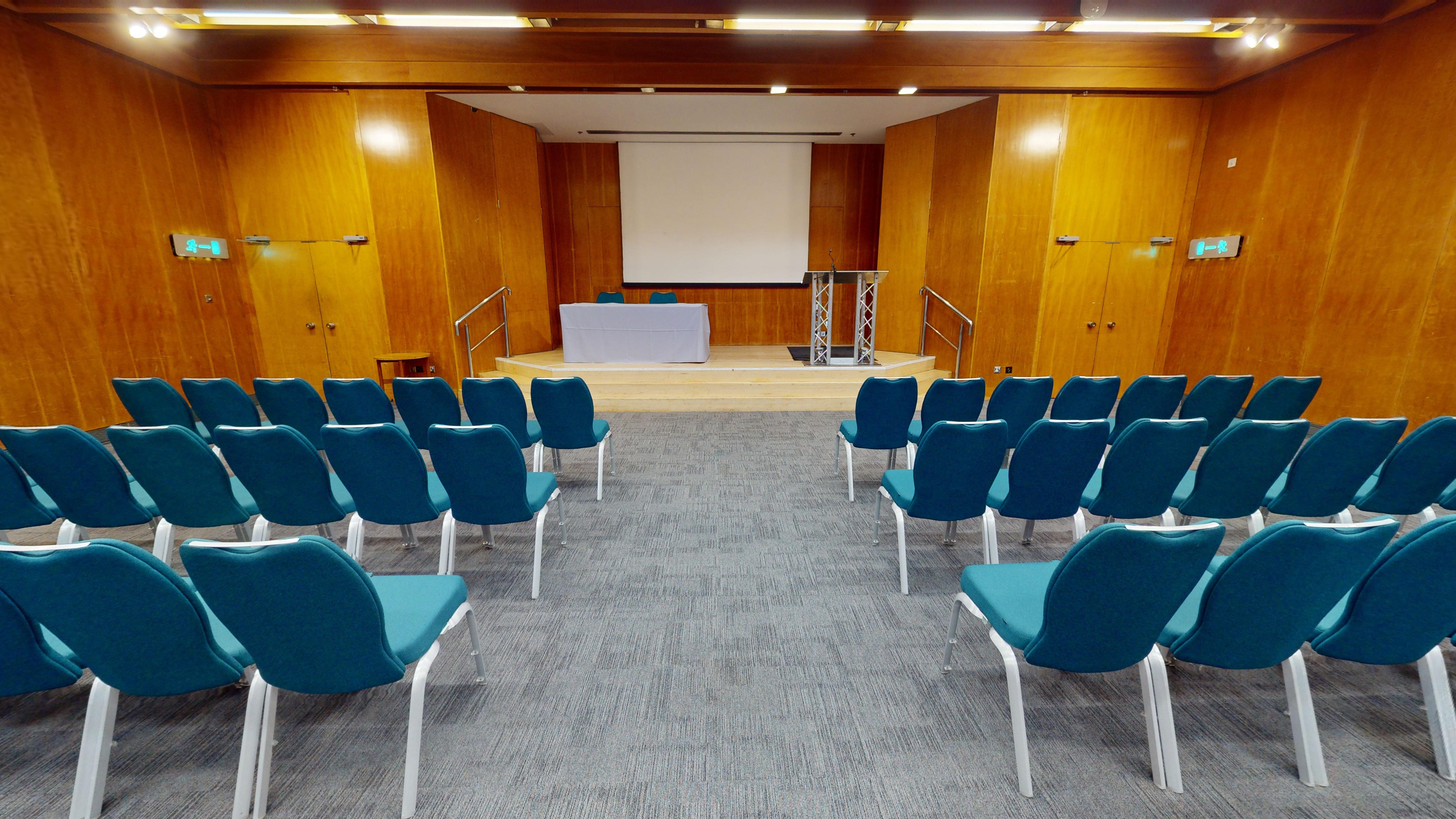 Modern conference room with teal chairs, ideal for meetings and presentations.
