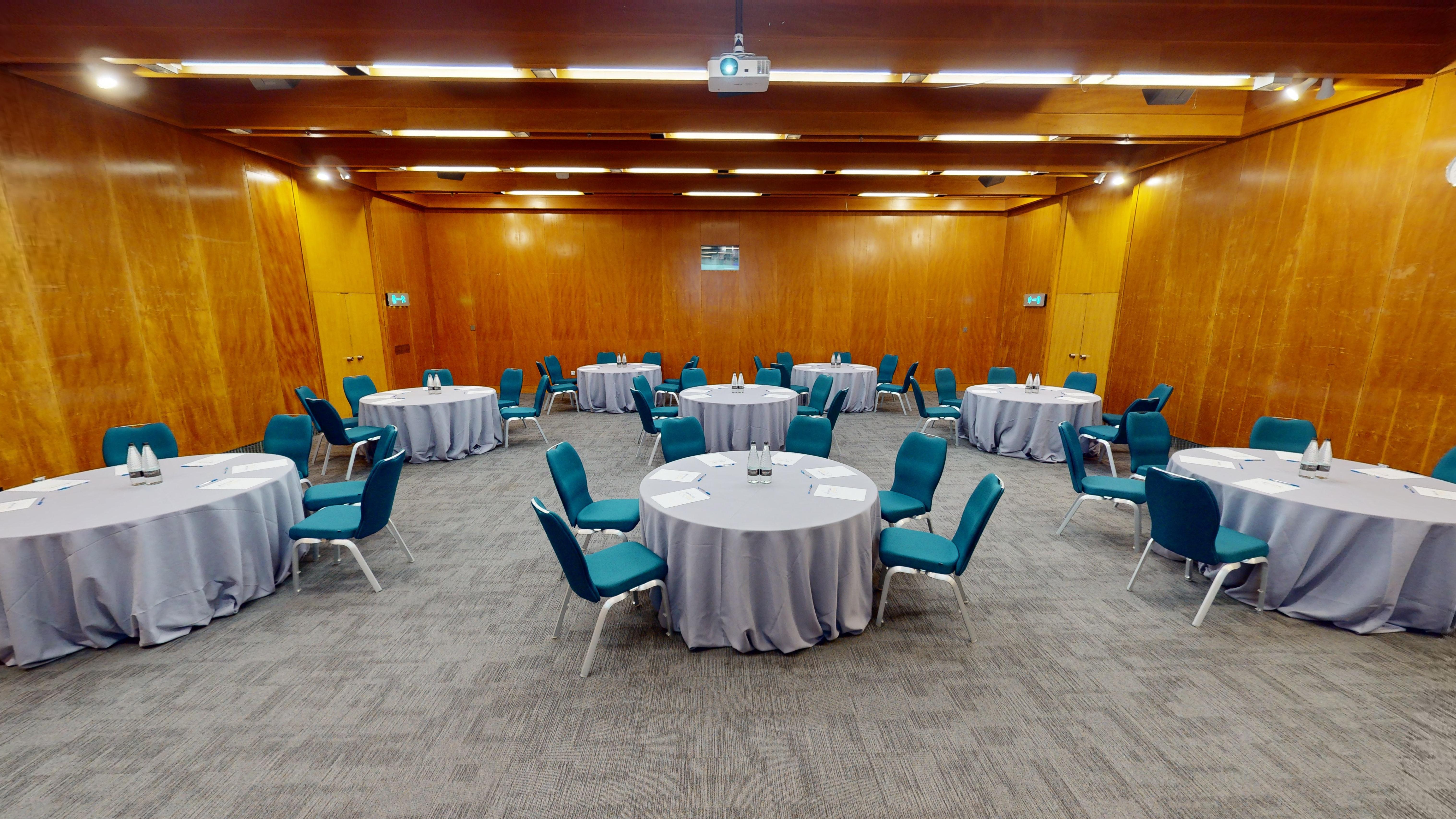 Small Hall at Kensington Centre: versatile meeting space with circular tables for workshops.