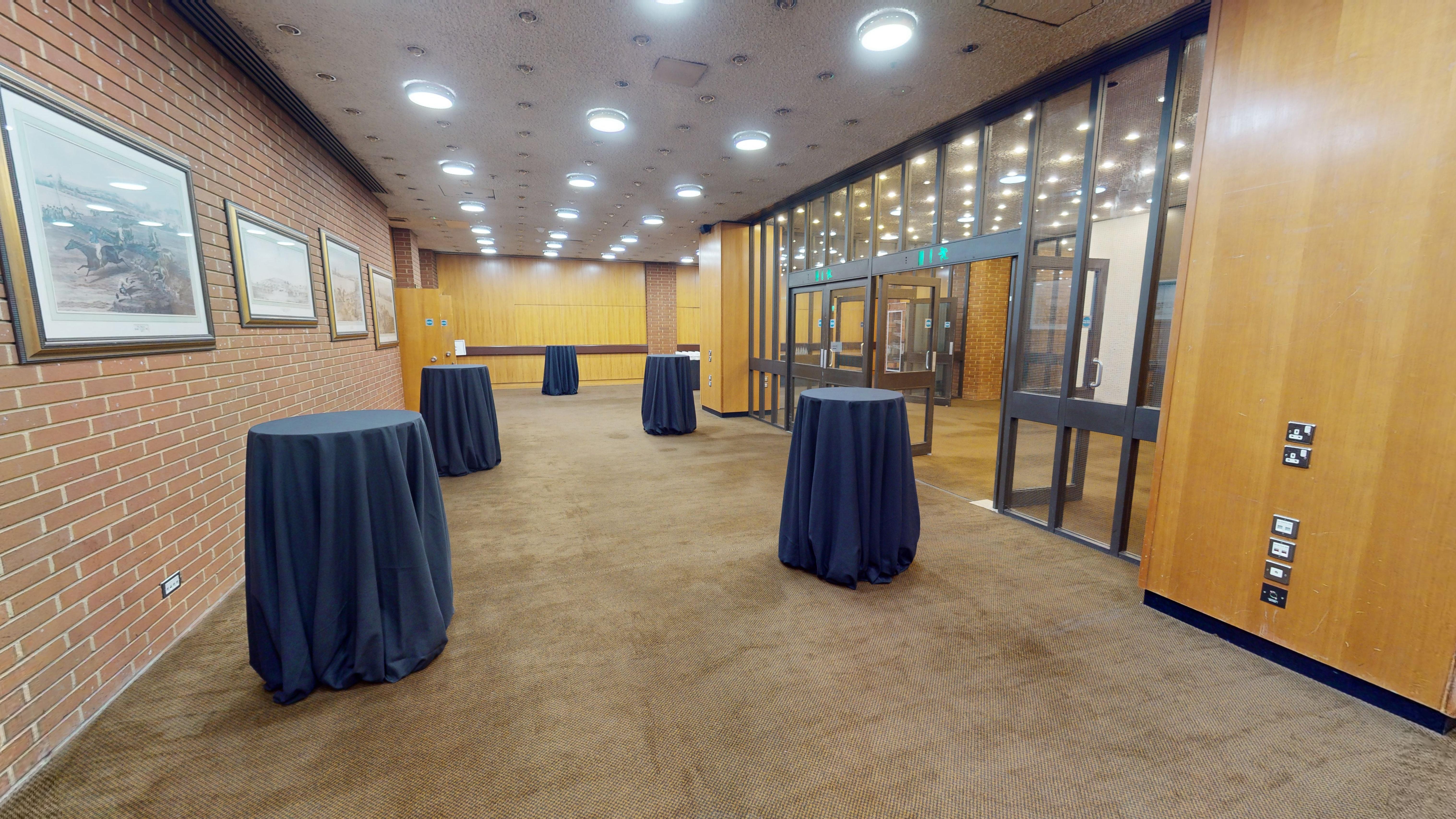 Spacious Small Hall with navy cocktail tables, perfect for networking events in Kensington.