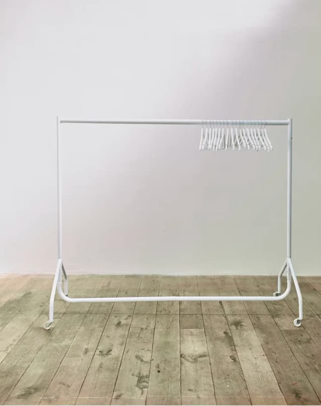 Minimalist clothing rack for event check-in in SW10 Studios, ideal for wardrobe management.