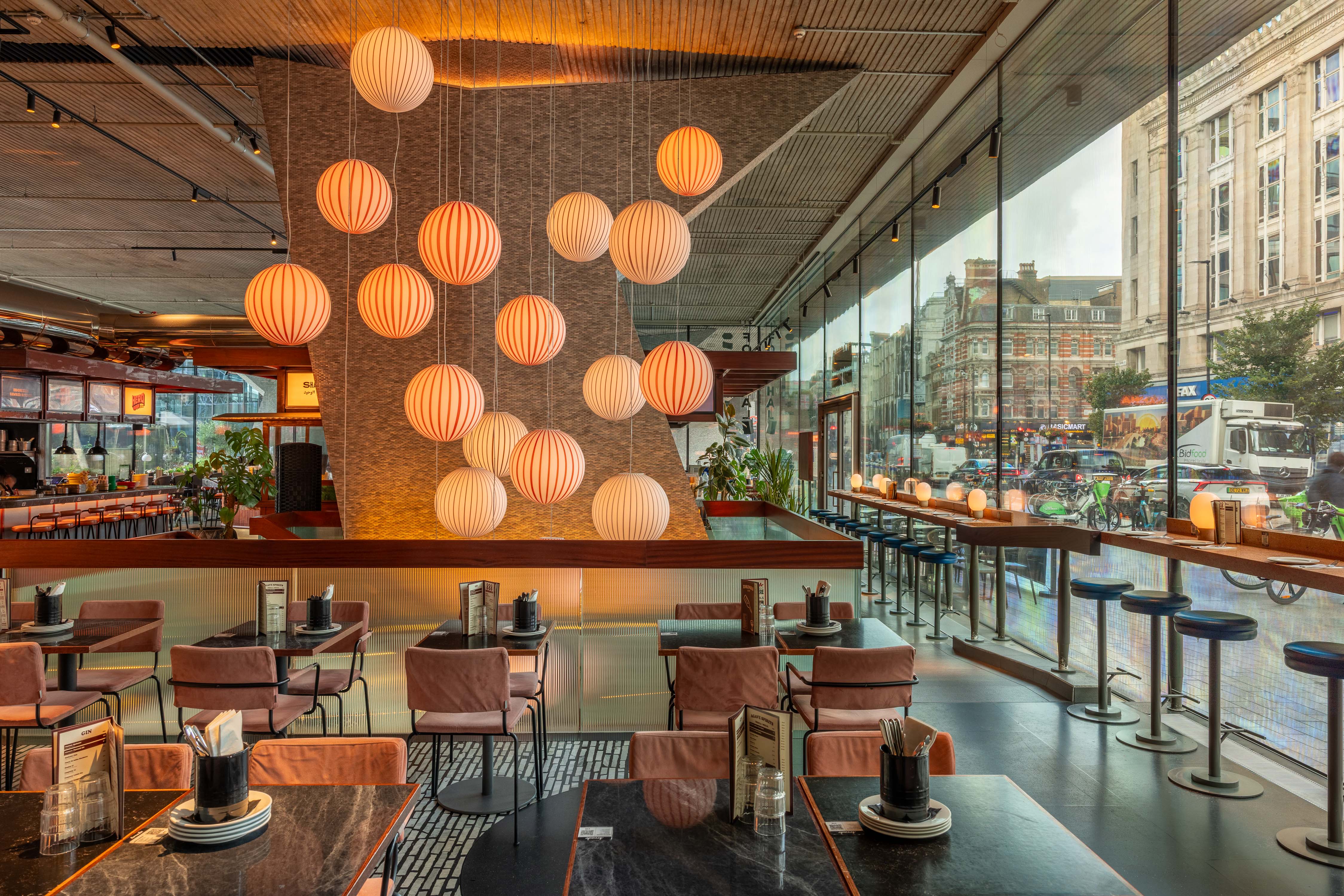 Modern restaurant space with warm lighting for corporate events in Tottenham Court Road.