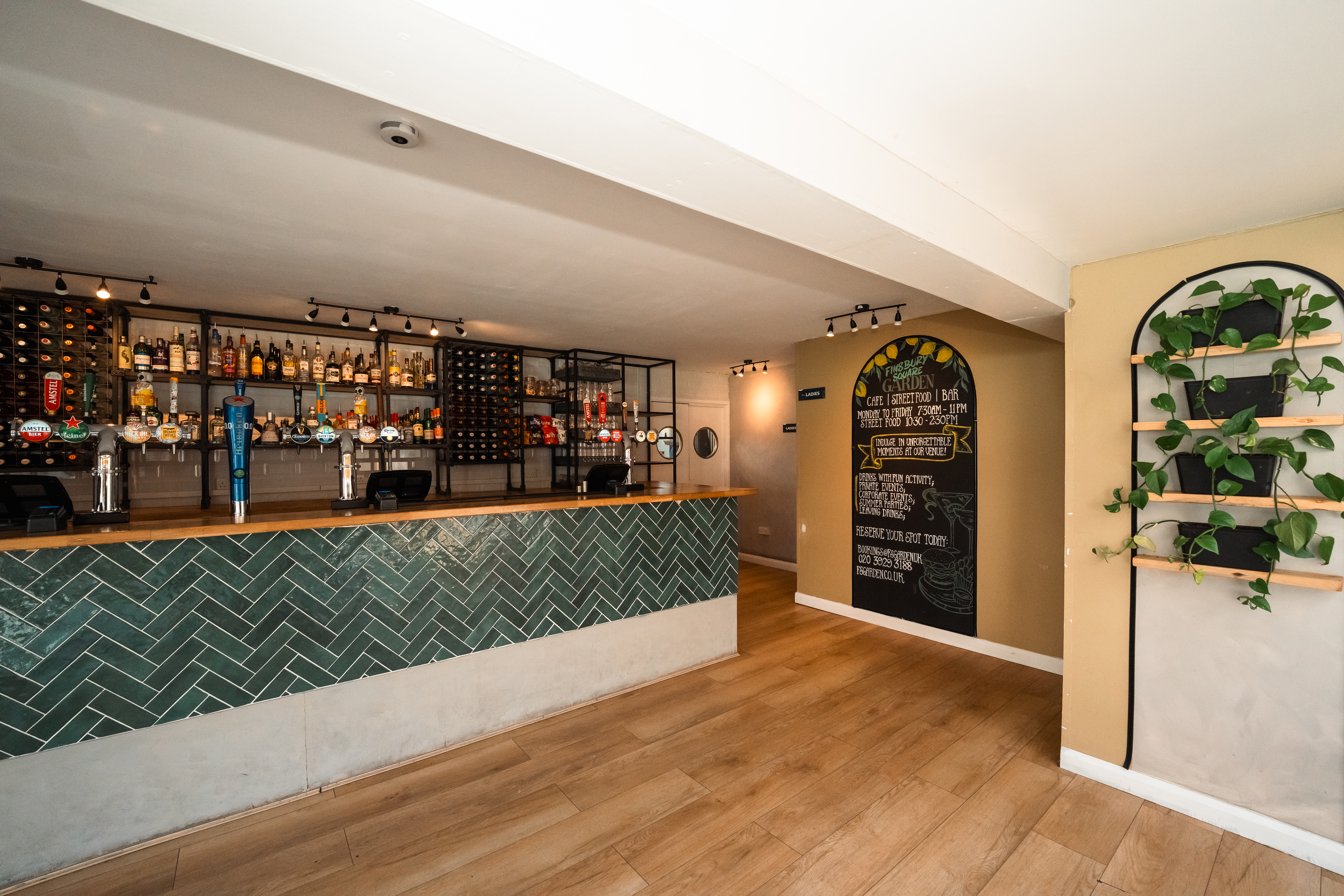 Modern bar area with herringbone design, perfect for networking events and meetings.