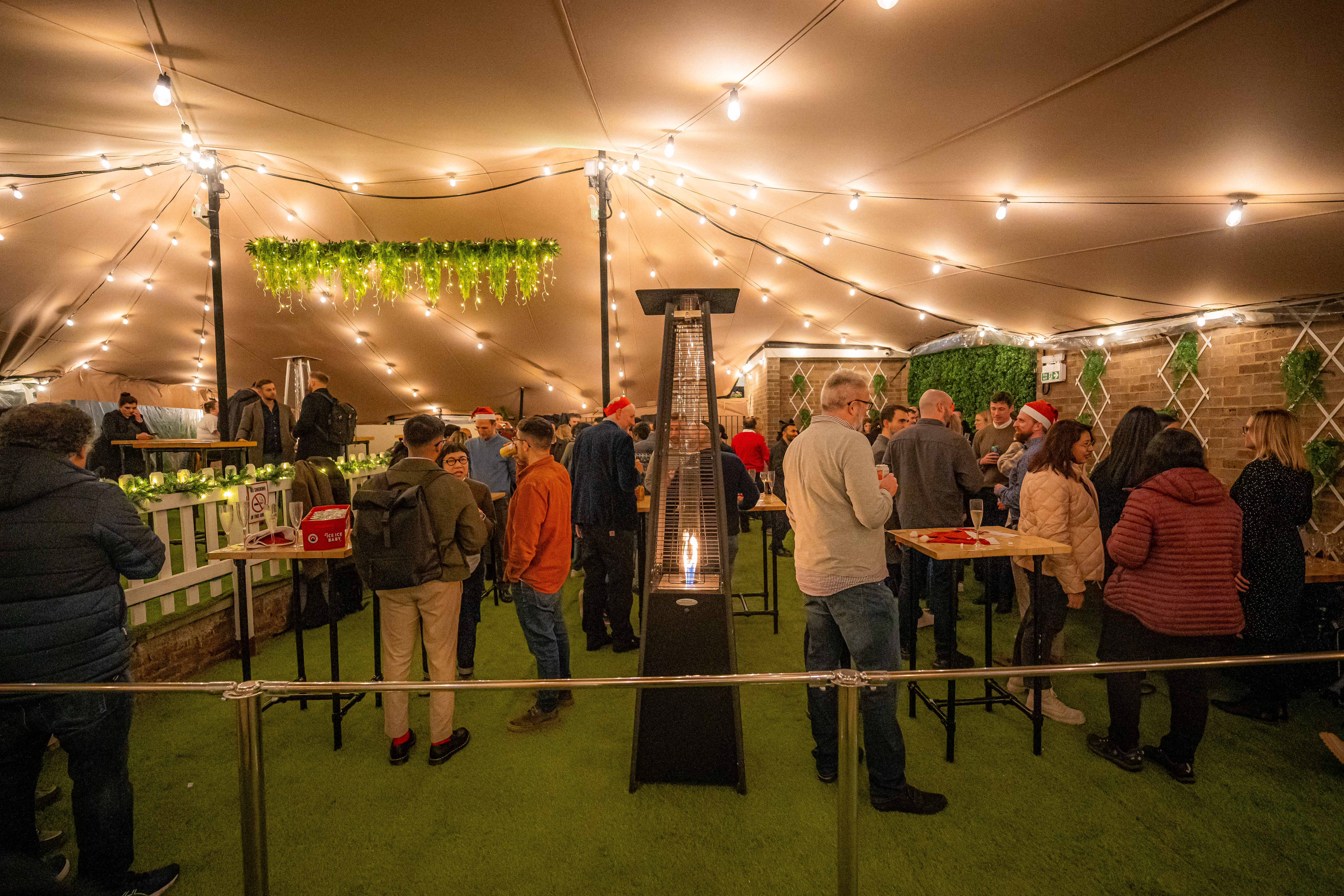 Festive event space in Finsbury Square Garden with cozy lighting and greenery.