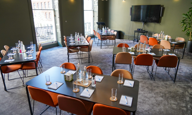 Mary Brancker at British Veterinary Association meeting with stylish orange chairs, event space layout.