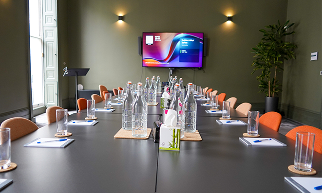 Mary Brancker in a modern veterinary meeting room with organized setup for presentations.