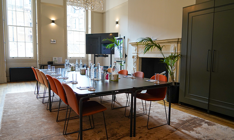George Fleming in a professional meeting room with modern decor, perfect for events.
