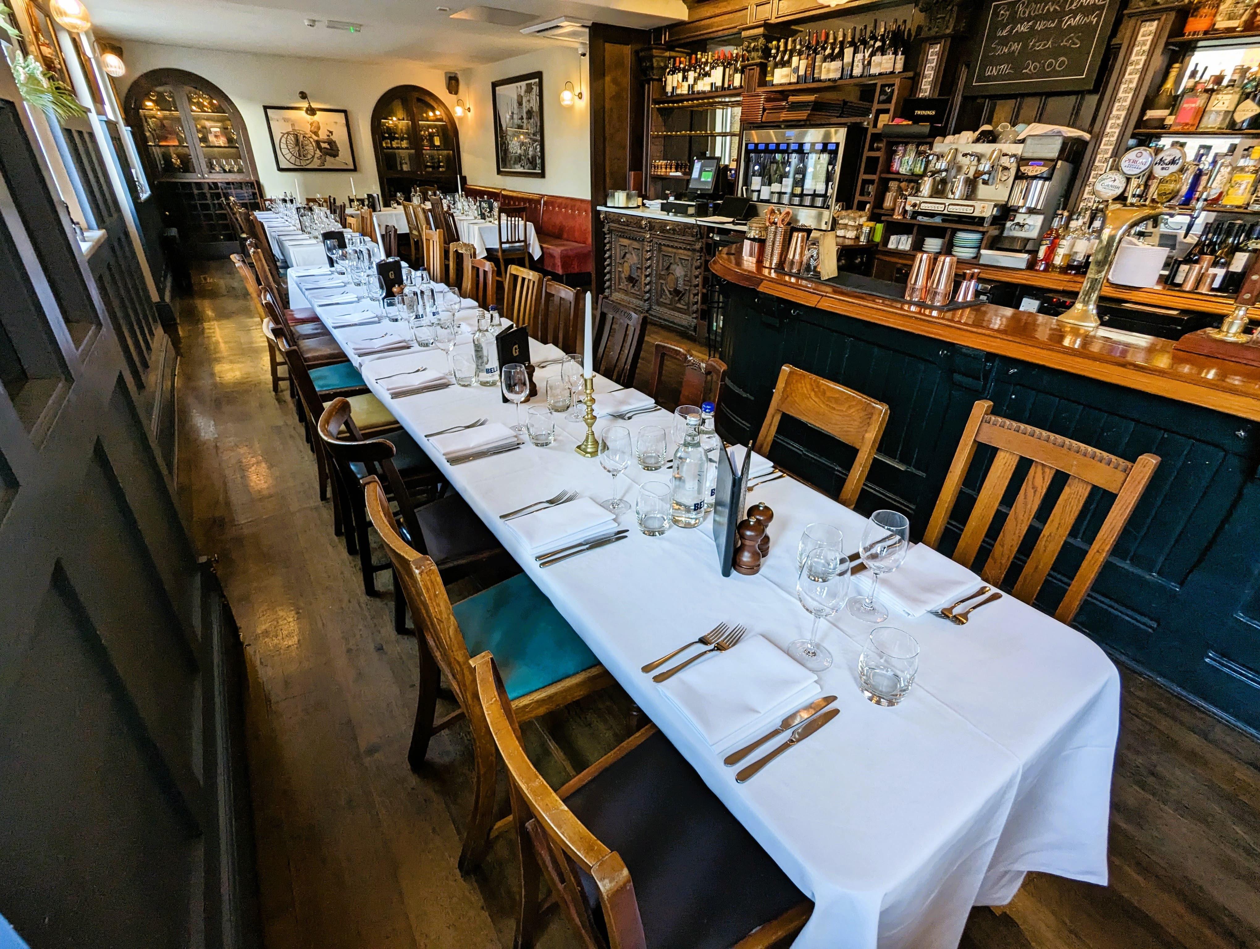 Elegant dining table setup in cozy restaurant for intimate gatherings and corporate dinners.