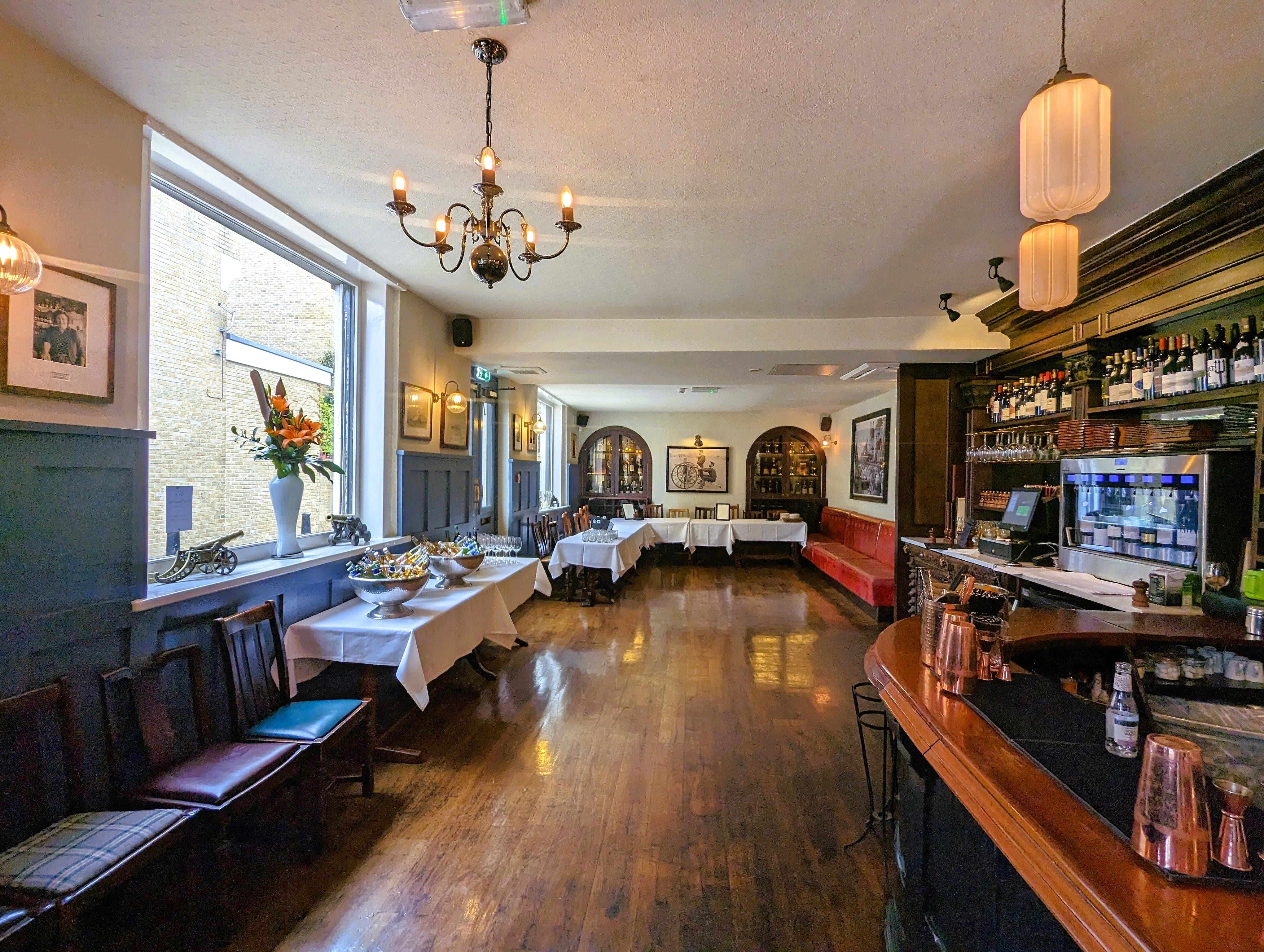 Elegant dining room at The Gun for private events and meetings, featuring ample natural light.
