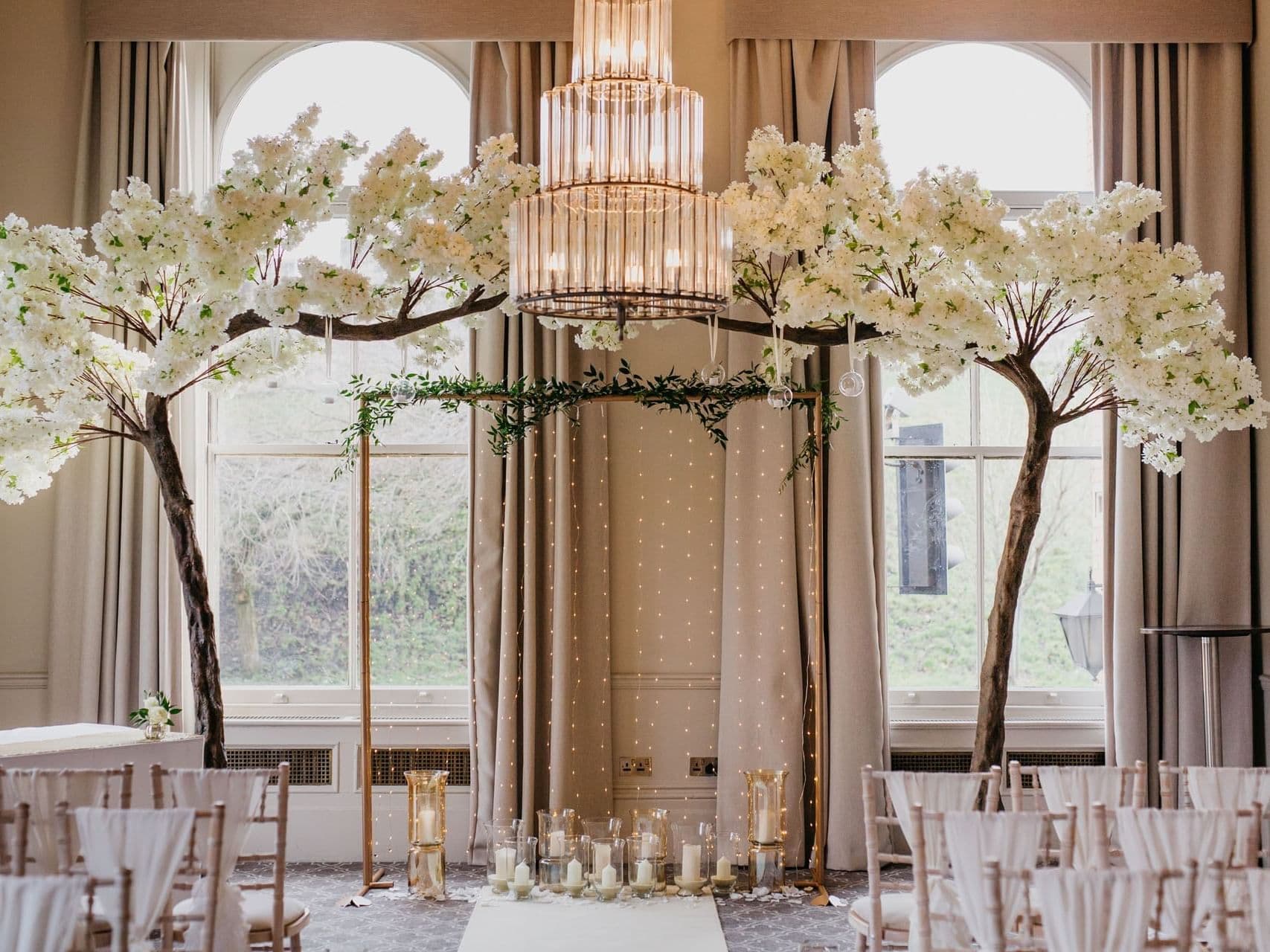 Elegant wedding venue with floral archway and chandelier ambiance in The Milner York.