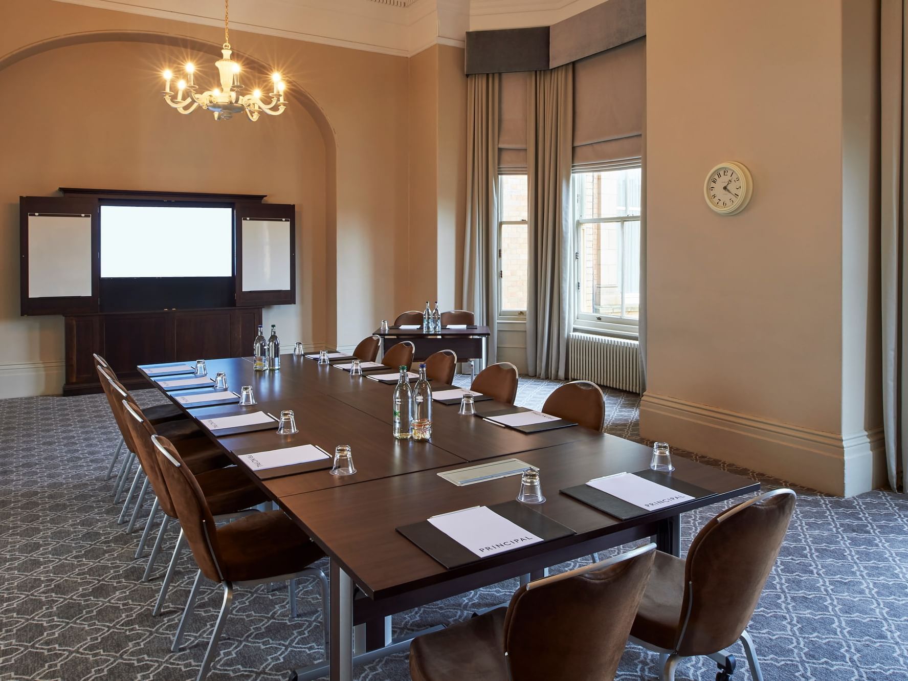 Elegant meeting room with wooden table, perfect for professional events and presentations.