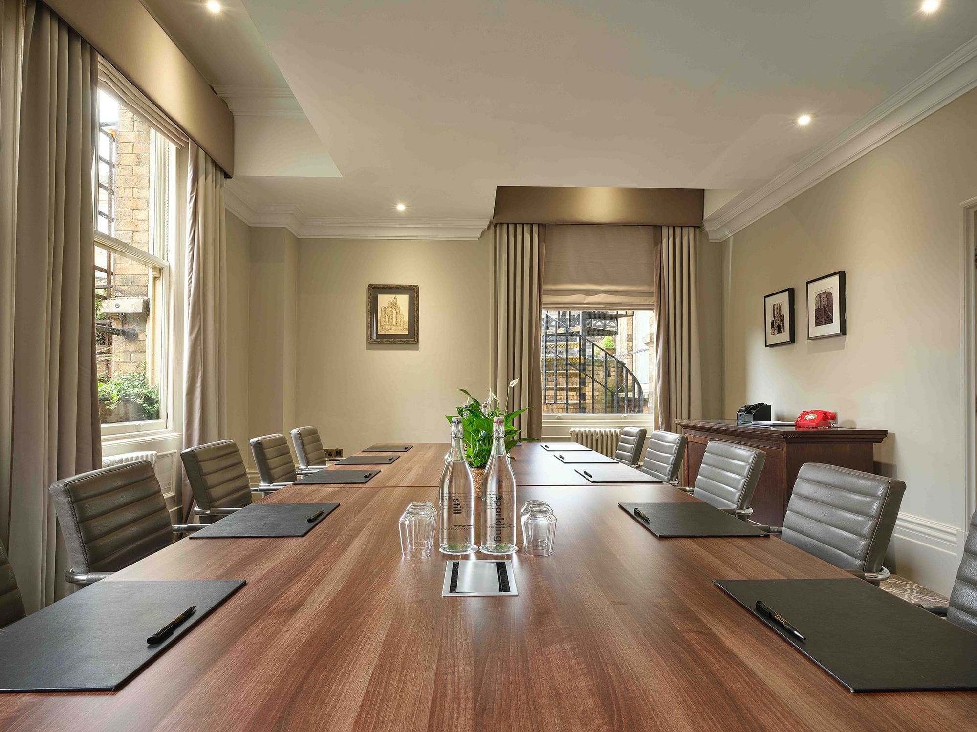 Meeting room in The Milner York with spacious table, ideal for corporate events.