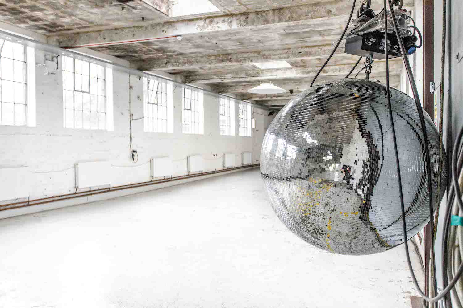 Penthouse Electrowerkz with large disco ball, ideal for creative events and gatherings.