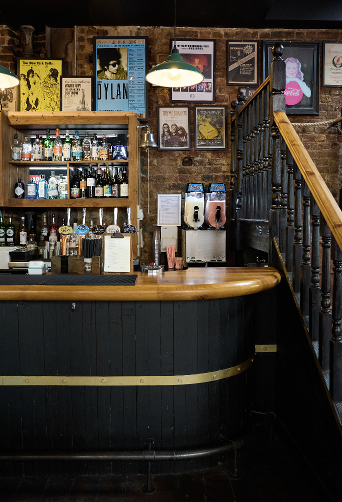 Main Bar at The Islington Townhouse with wooden counter, ideal for networking events.