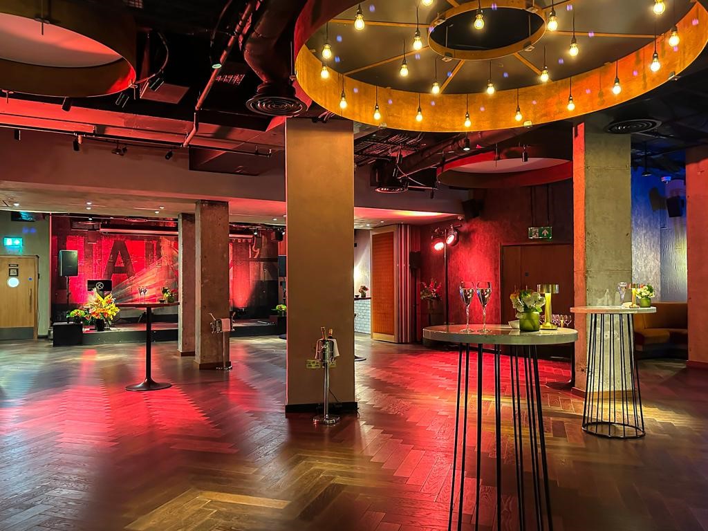 Stylish QT Basement Bar event space with vibrant lighting for gatherings and corporate events.