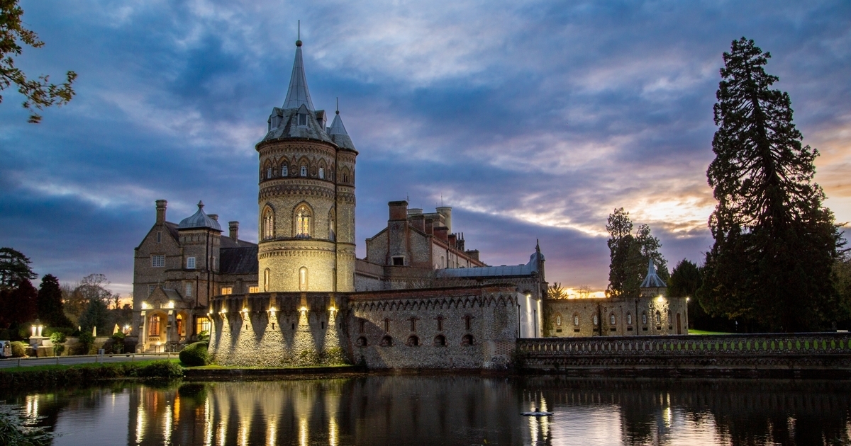 Twilight view of De Vere Horsley Estate castle, perfect for events and weddings.