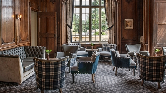 Sophisticated meeting space at De Vere Horsley Estate with plush seating for gatherings.