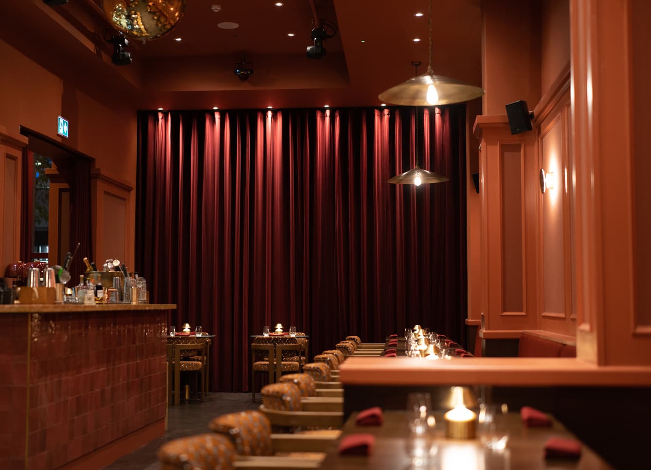 Shakara main room with dramatic stage curtains for corporate events and private dinner parties.