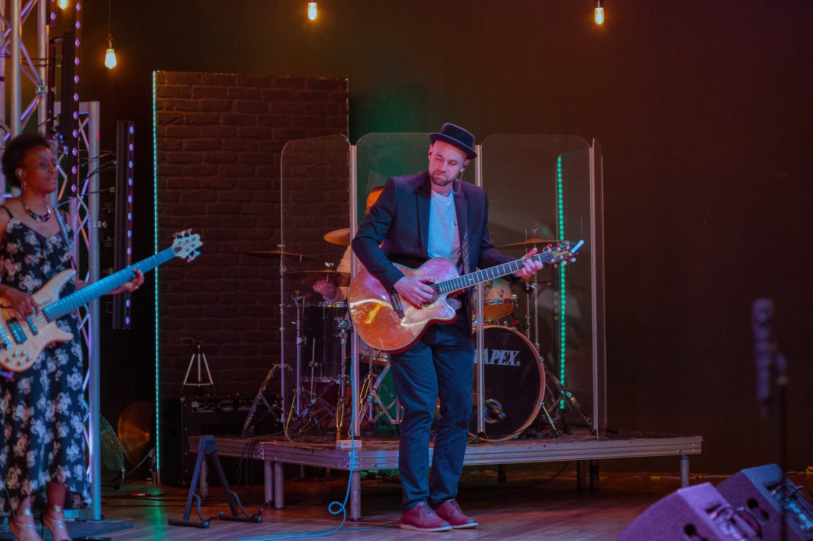 Vibrant live concert in Victory Outreach Manchester with musician and instruments on stage.