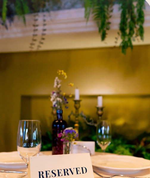 Intimate Fiorenza London table setting with gold candelabras for boutique dinner and micro-events.