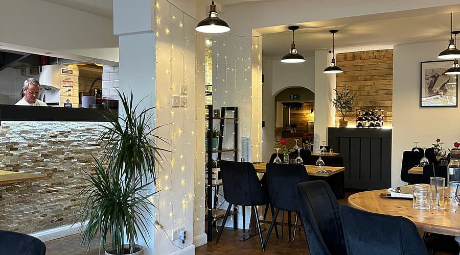 Modern Pecorino Restaurant interior with warm lighting for team dinners and networking events.