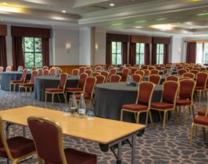 College Suite conference room with hybrid table setup for corporate meetings and business events.