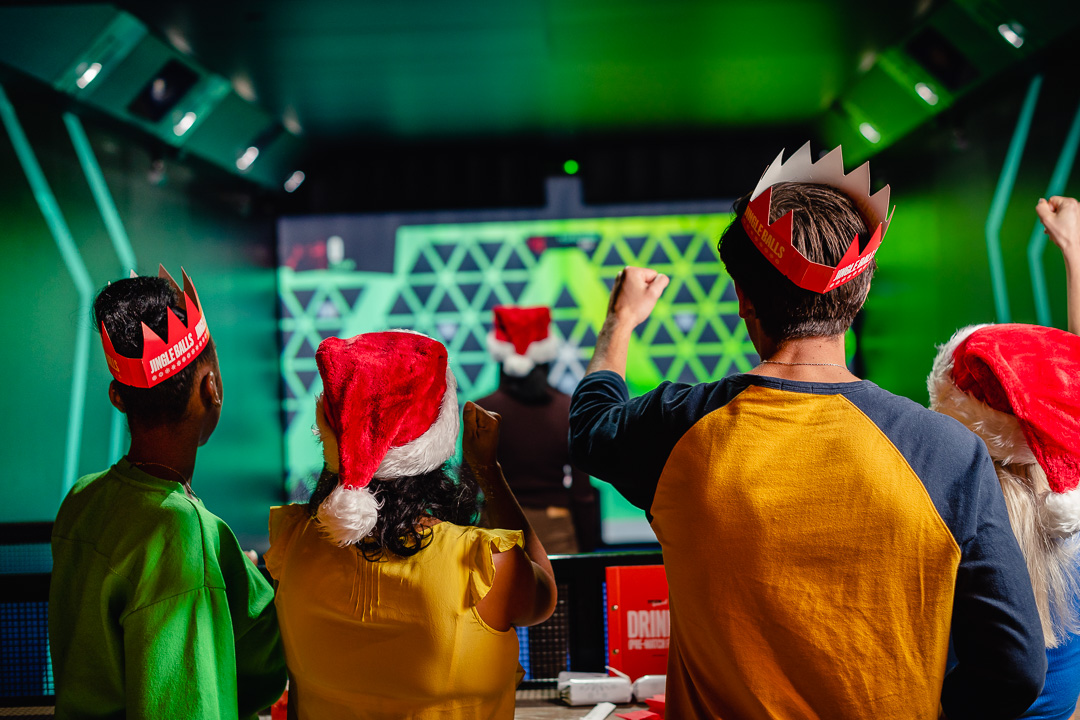 Team-building event at TOCA Social Birmingham with festive attire and vibrant backdrop.