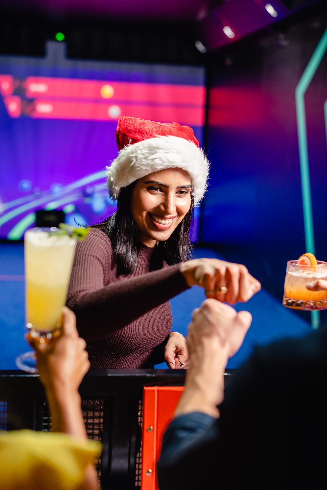 Festive TOCA Social venue in Birmingham for corporate Christmas events, featuring Santa hat.