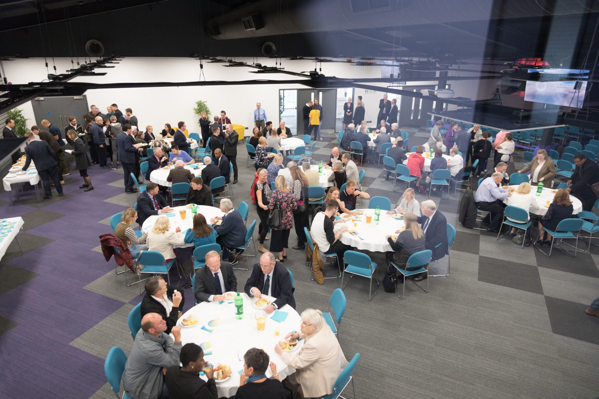 New Life Wesleyan Church banquet room with round tables for networking and church events.