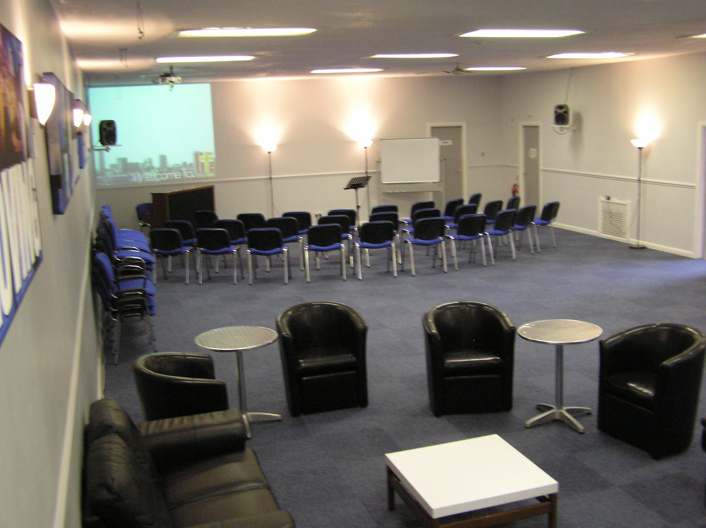 New Life Wesleyan Church meeting room: hybrid theater-lounge space for professional events.