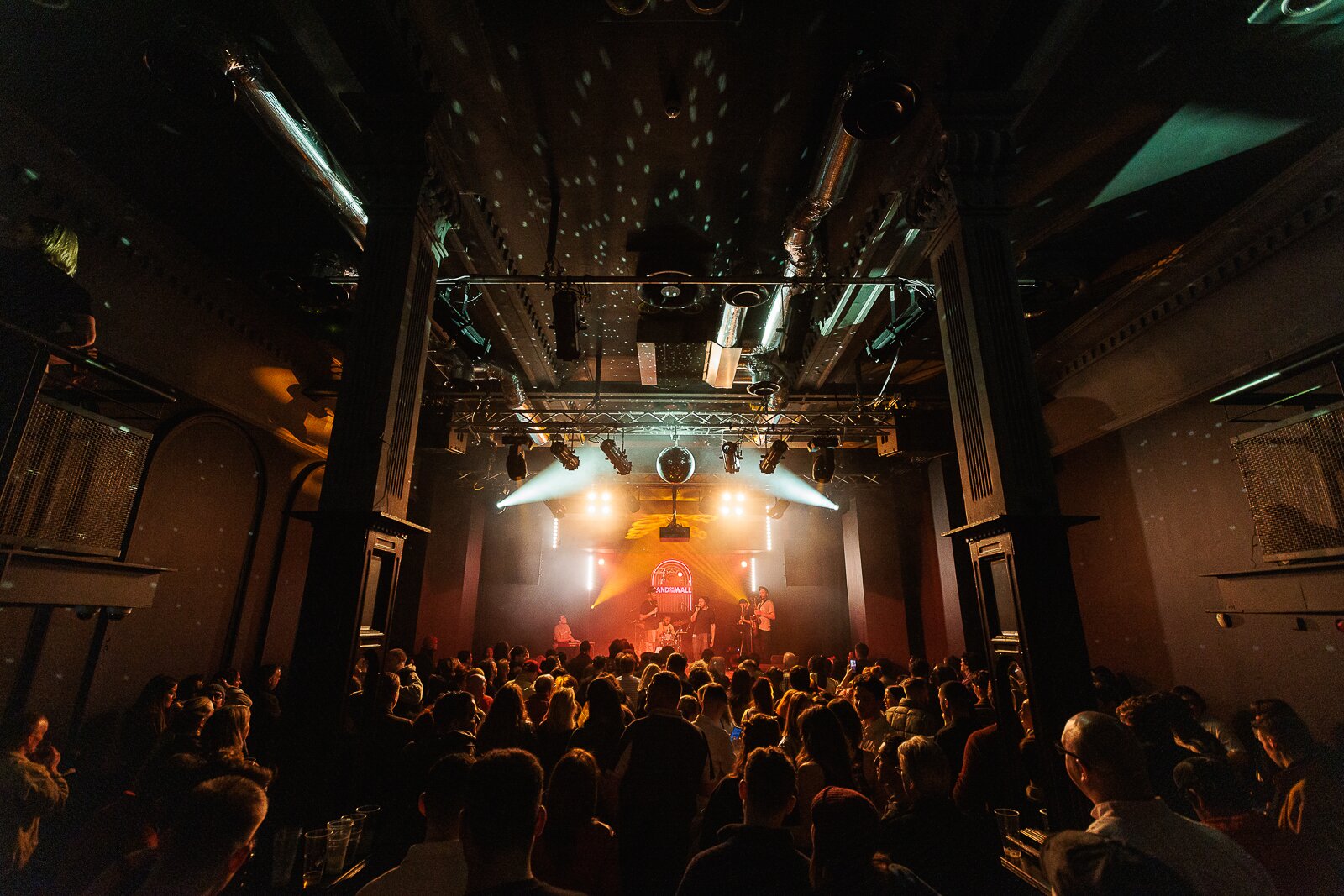 Live concert at Band on the Wall with dramatic industrial lighting, perfect for events or music gigs.