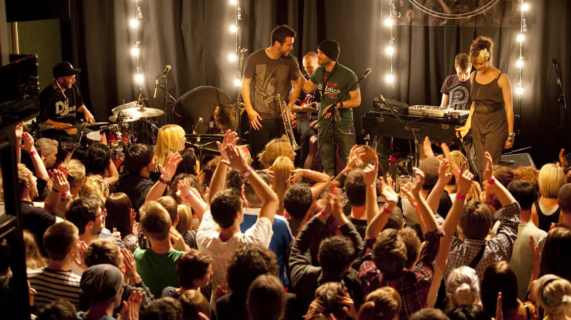 Intimate Band on the Wall concert stage with dramatic string lighting for live music events.