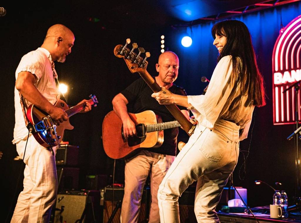 Live music act with dynamic stage lighting at a professional concert venue for event production.