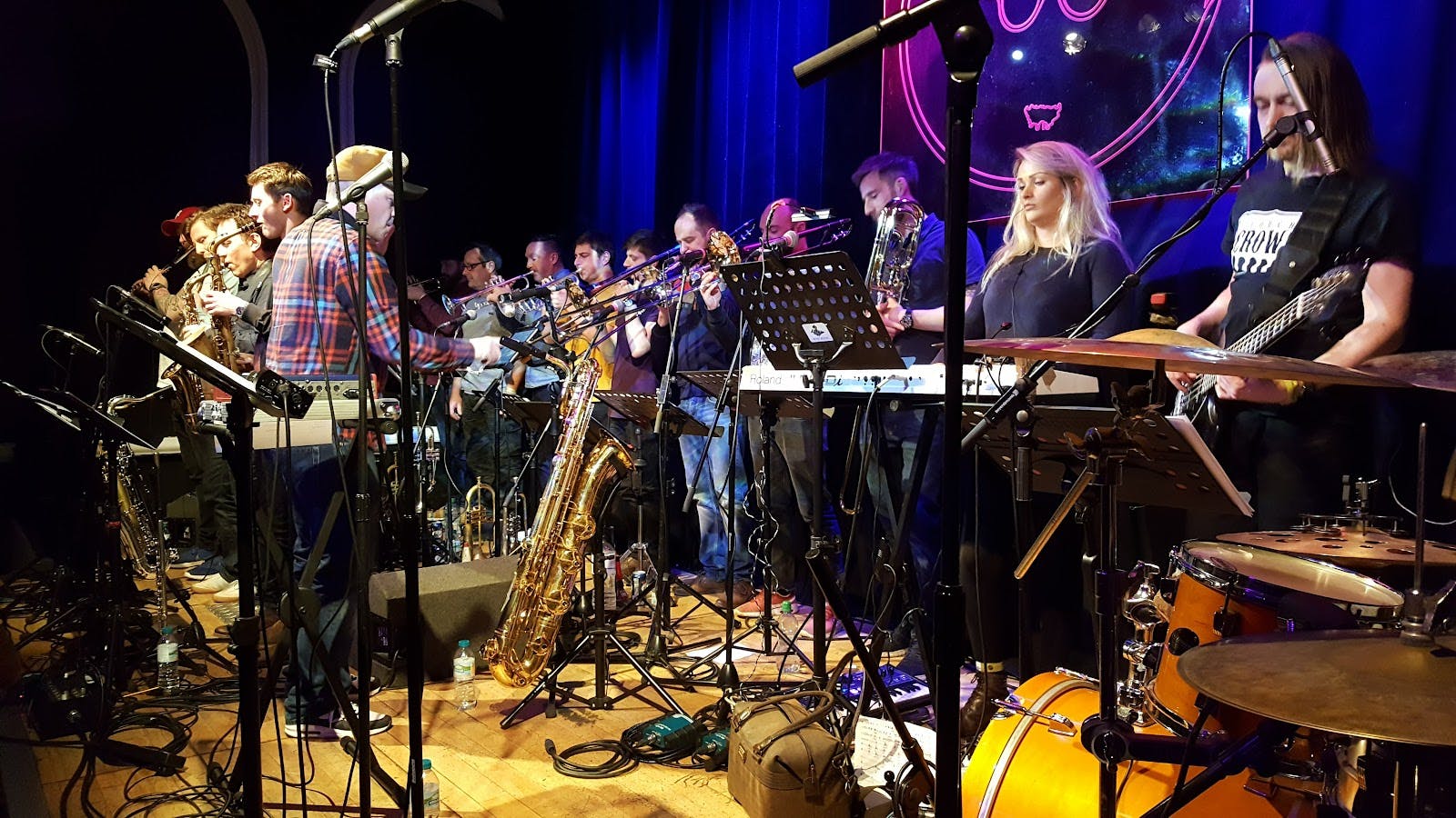 Band on the Wall education center with large ensemble on stage for live music event production.