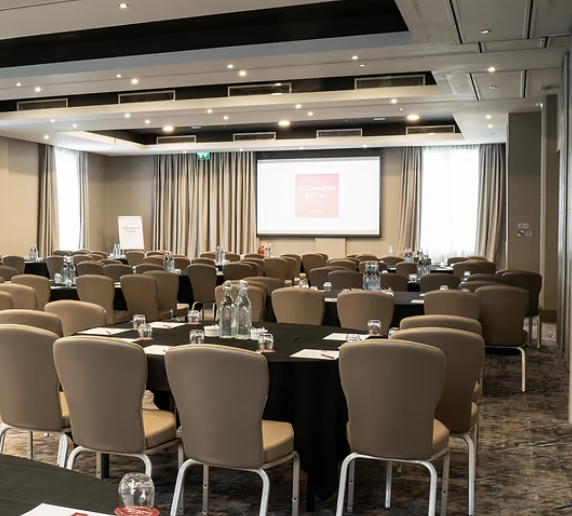 University Suite at Leonardo Royal Hotel Oxford, ideal meeting space with round tables.