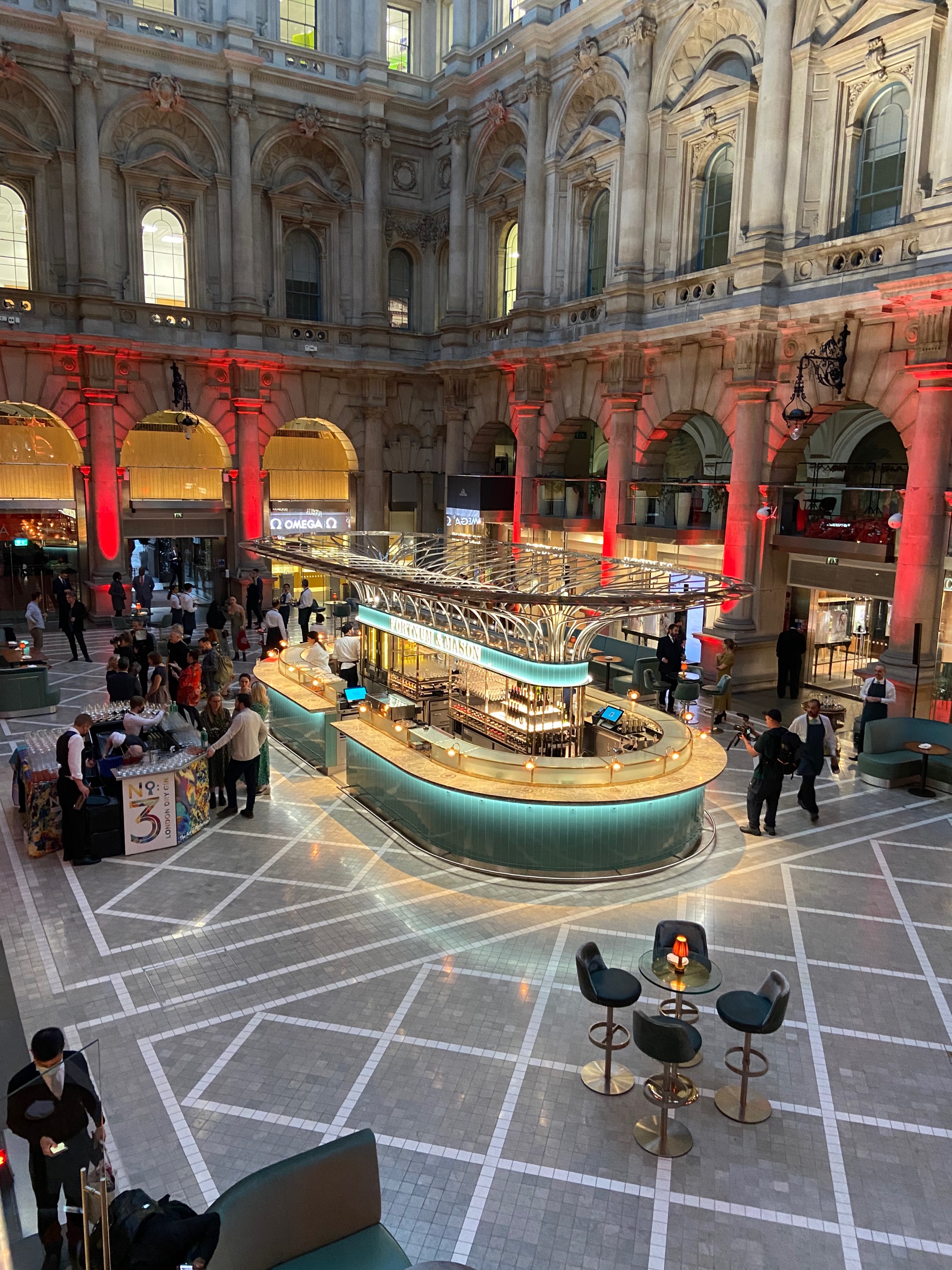Vibrant event space at Fortnum, modern bar and lively crowd for networking receptions.
