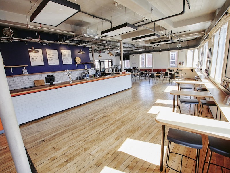 Industrial-chic Theatre Bar: Versatile networking venue for corporate events and workshops.