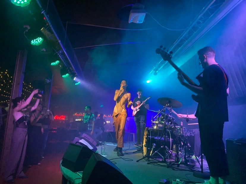 Live music event at Nocturna Club, vibrant atmosphere with colorful lighting.