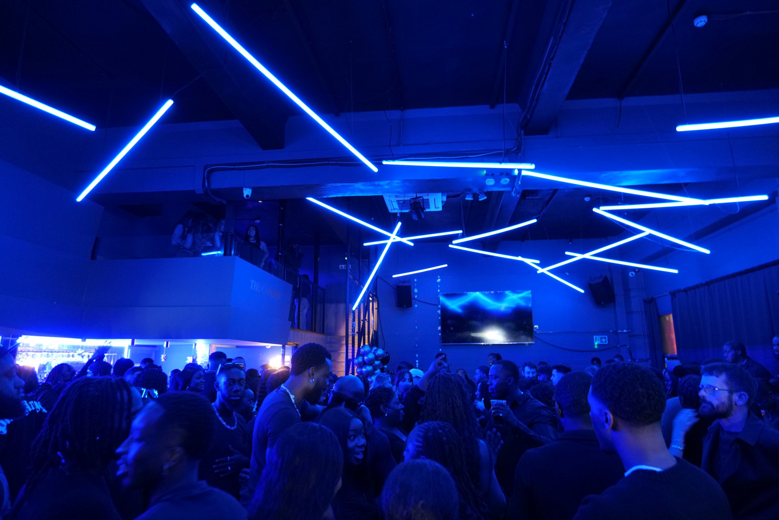 Nocturna Club: vibrant event space with blue lighting for networking and celebrations.