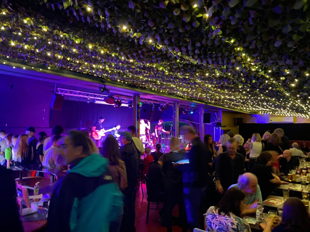 Nocturna Club event with live music and fairy lights in Camden for networking and celebration.