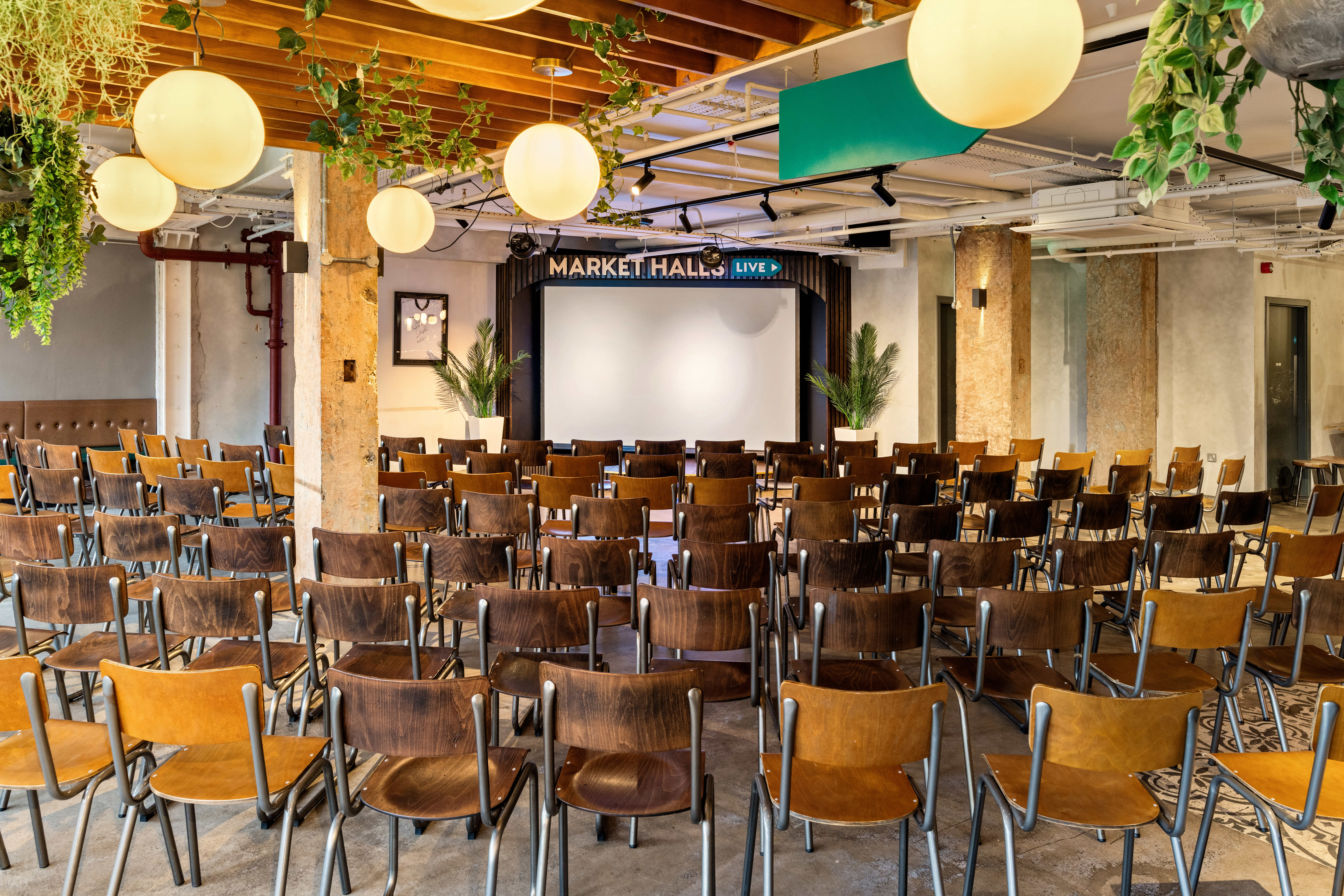 Event space at Market Halls Oxford Street with wooden chairs for presentations and networking.