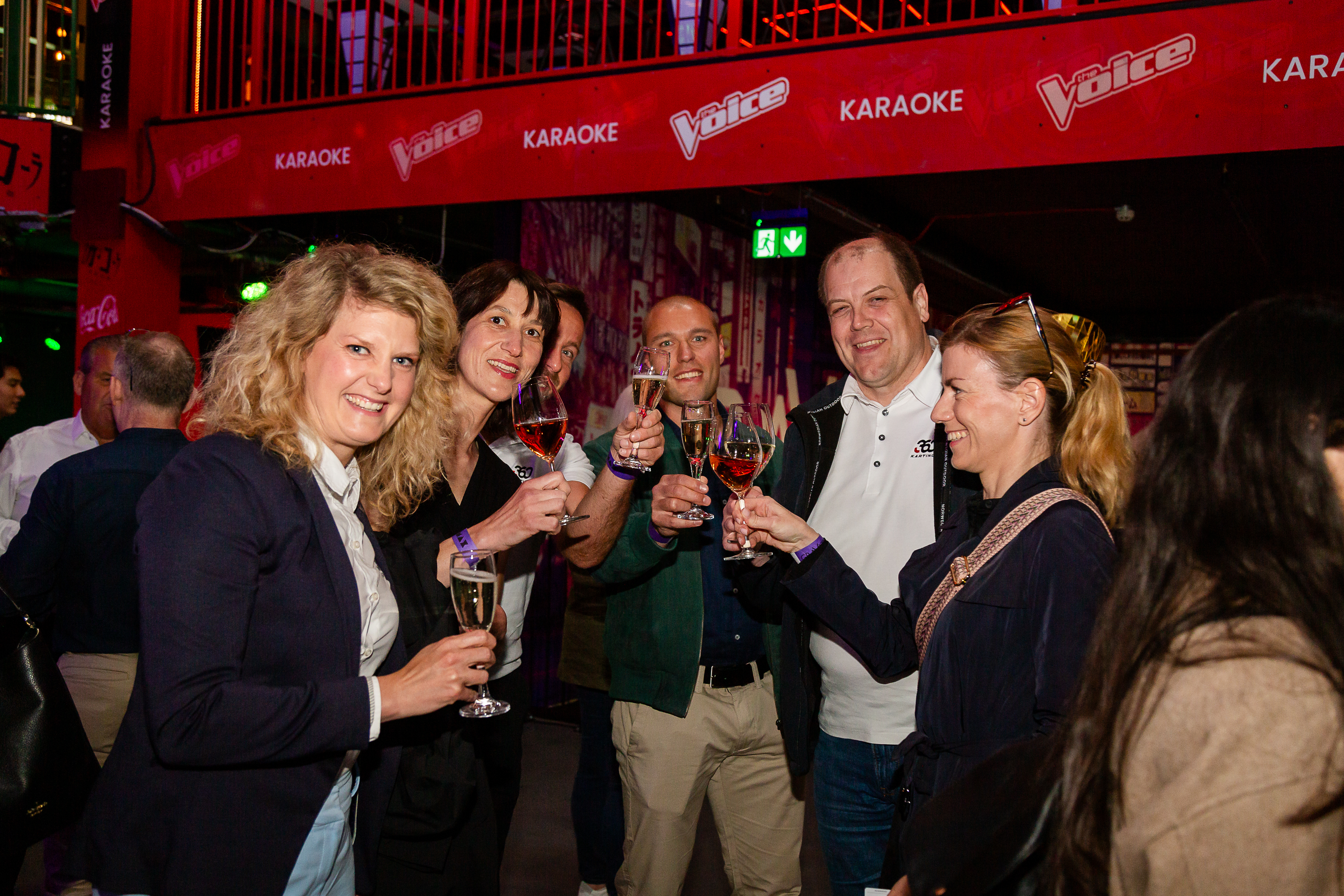 Lively networking event at Gravity Westfield Stratford with celebratory toasts and karaoke.