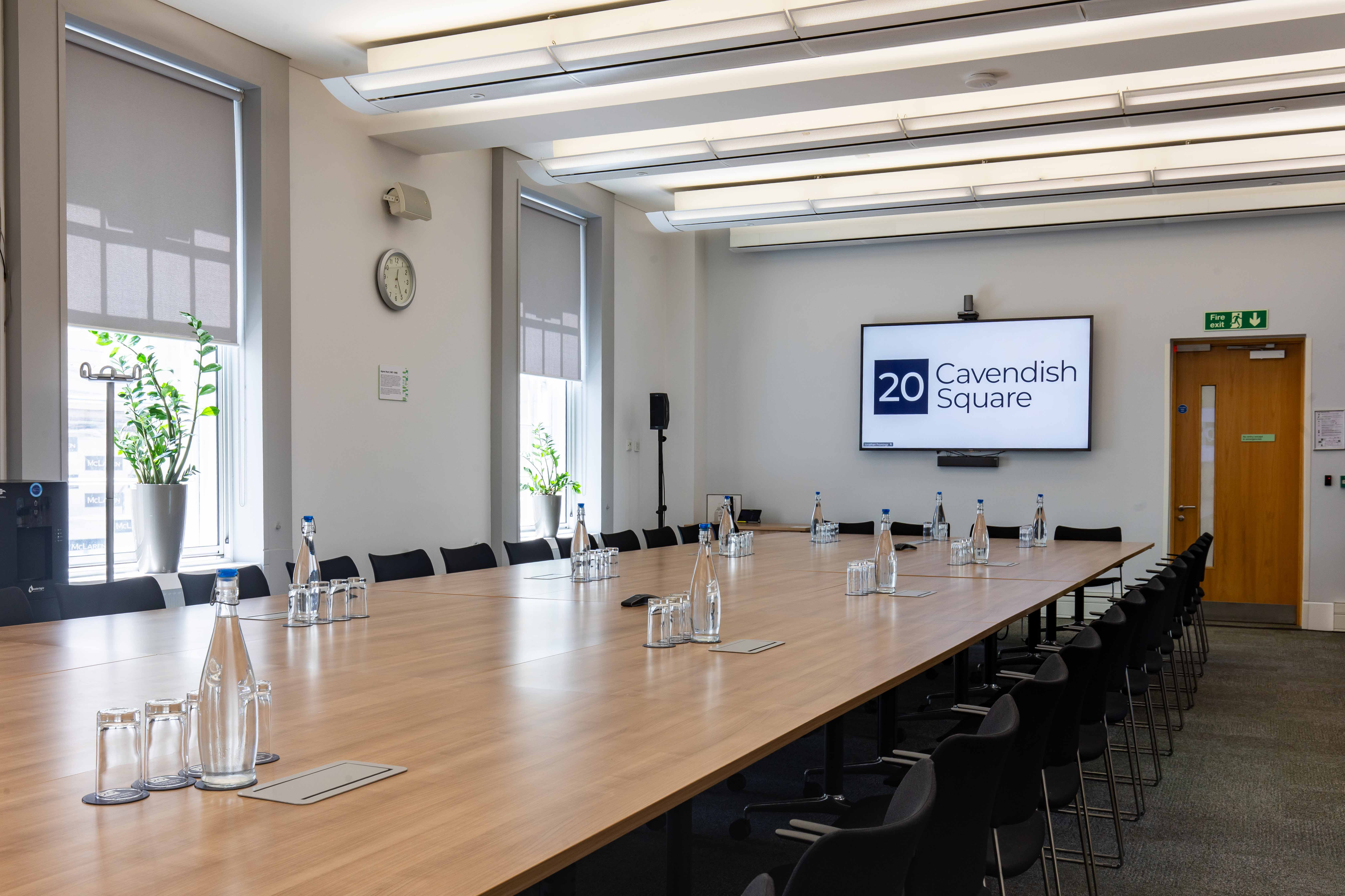 Modern meeting room at Cavendish Square with a large wooden table, ideal for workshops.